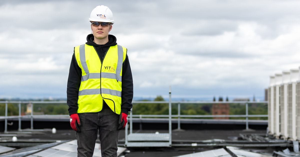 Solar installer fitting panels on a residential rooftop